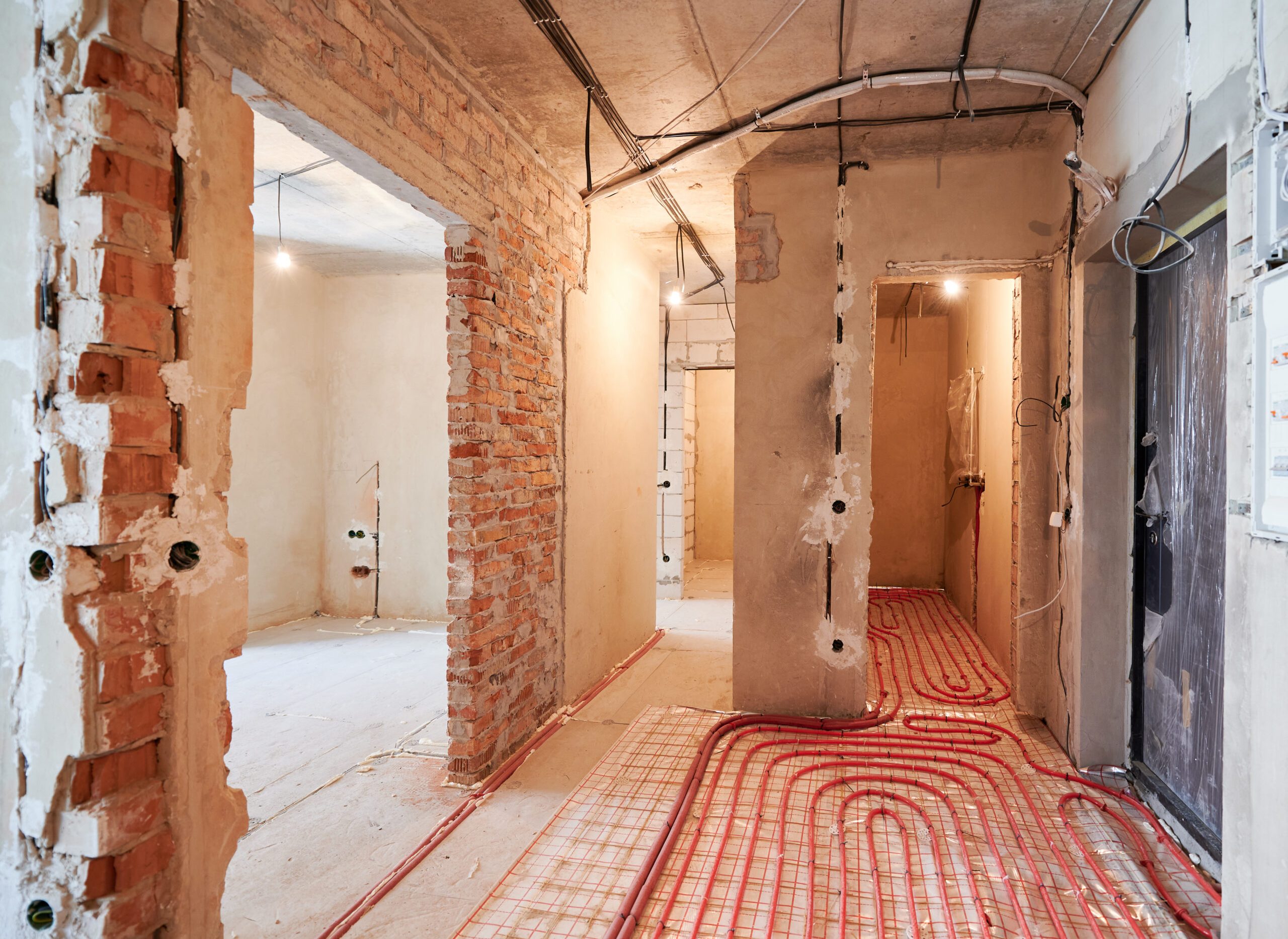 Comparison of old flat with underfloor heating pipes and new renovated apartment with modern interior design. Hallway with heated floor before and after renovation.