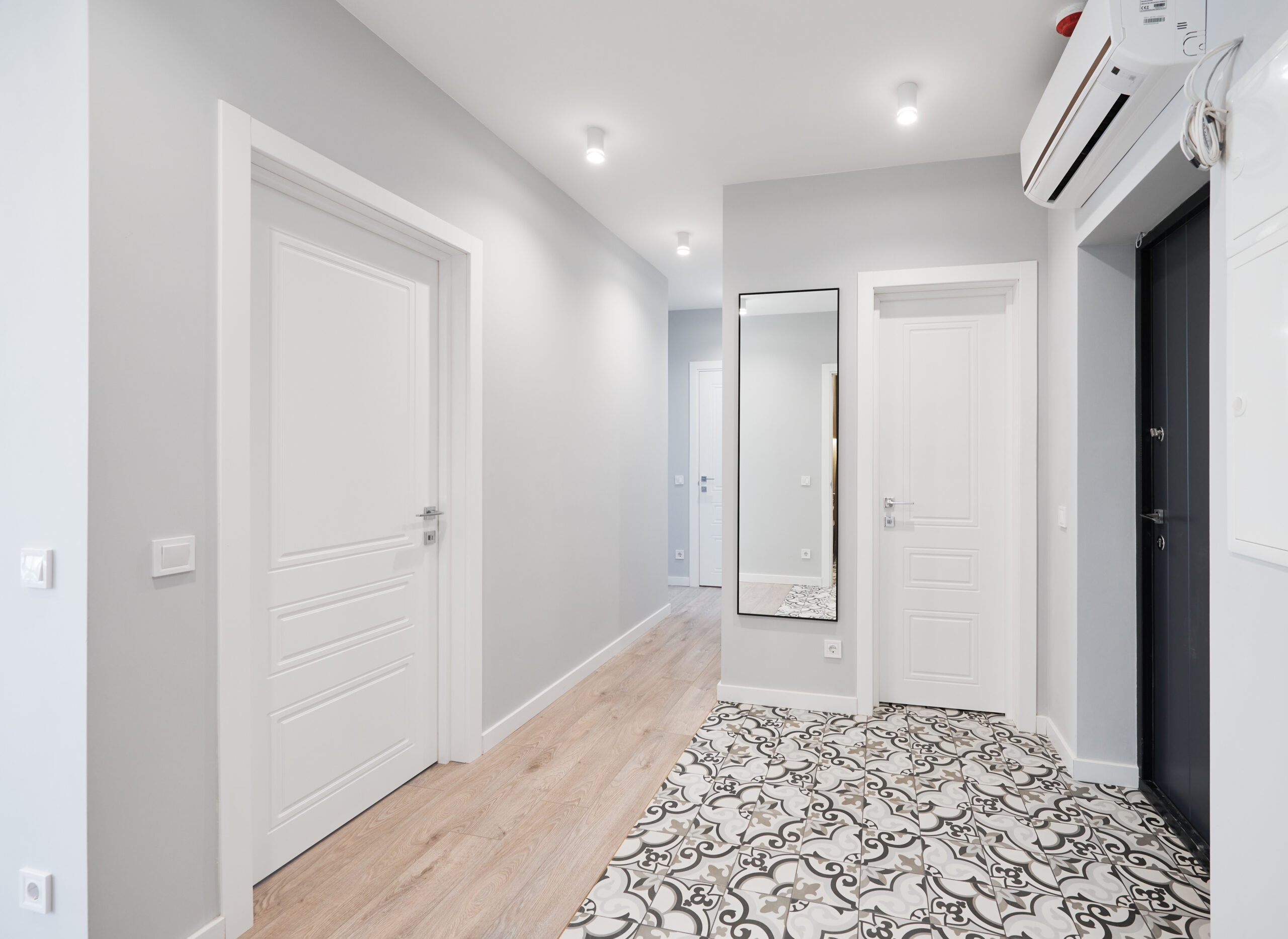 Comparison of old flat with underfloor heating pipes and new renovated apartment with modern interior design. Hallway with heated floor before and after renovation.